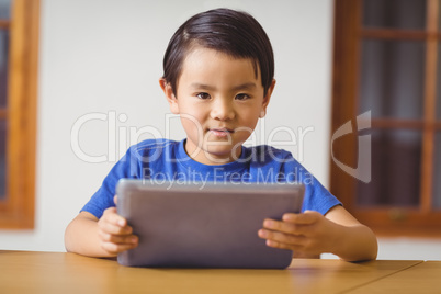 Cute pupil in class using tablet pc