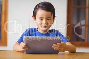 Cute pupil in class using tablet pc