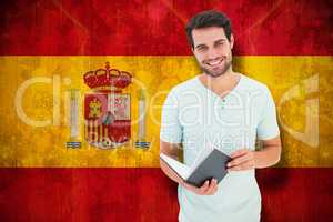 Composite image of student holding book