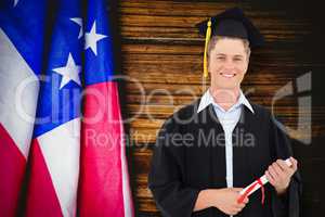 Composite image of man smiling as he has just graduated with his