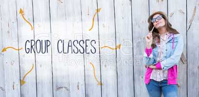 Group classes against thoughtful woman holding paint brush