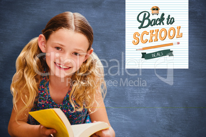 Composite image of cute little girl reading book in library