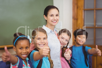 Teacher and pupils smiling in classroom