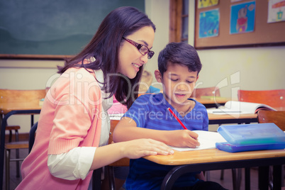 Happy teacher helping her students