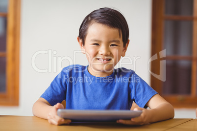 Cute pupil in class using tablet pc