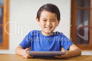 Cute pupil in class using tablet pc