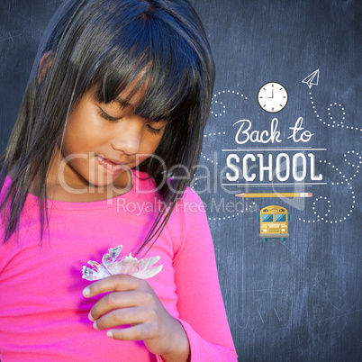 Composite image of cute little girl holding flower