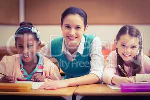 Teacher helping pupils during class