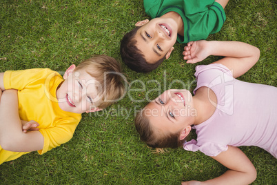 Smiling pupils lying on the ground