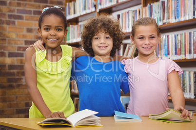 Happy pupils reading a library book