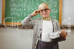 Smiling pupil dressed up as teacher holding books
