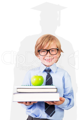 Composite image of cute pupil holding books and apple