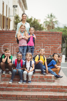 Cute pupils with teacher outside