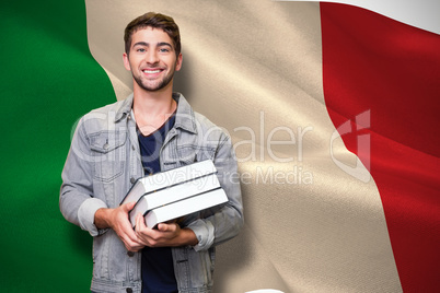 Composite image of student smiling at camera in library