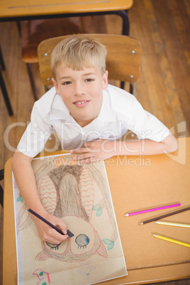 Student drawing on a sheet of paper