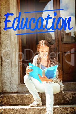 Education against smiling student sitting and reading book