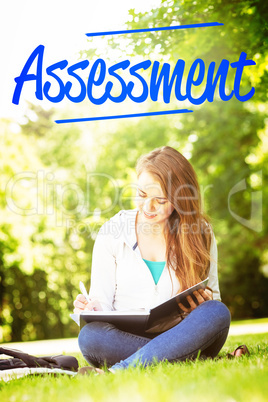 Assessment against smiling university student sitting and writin