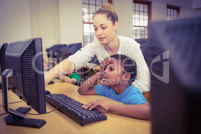 Teacher showing student how to use a computer