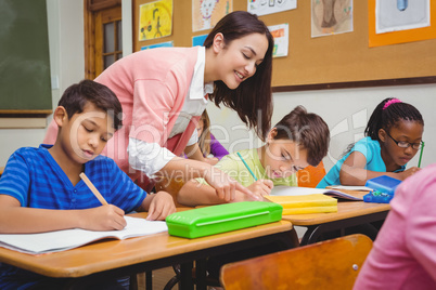 Smiling teacher helping a student