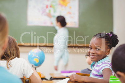 Pupil smiling at camera during class