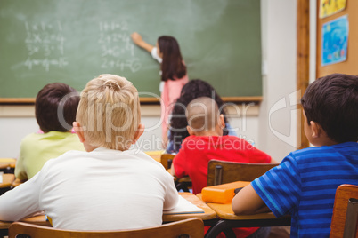 Teacher writing on the blackboard