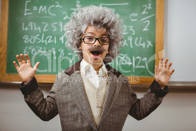 Little Einstein smiling in front of chalkboard