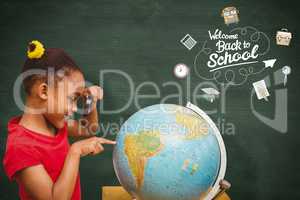 Composite image of pupil studying the globe