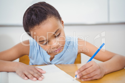 Pupil writing into a notebook