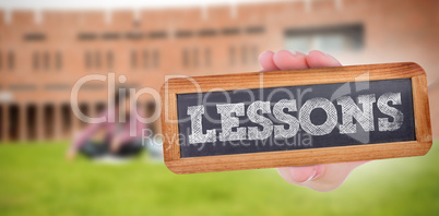 Lessons against students using laptop in lawn against college bu