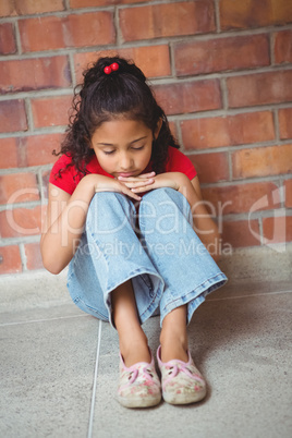 Upset lonely girl sitting by herself