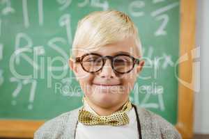 Smiling pupil dressed up as teacher in a classroom