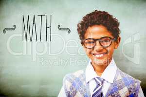 Math against cute little boy smiling in classroom