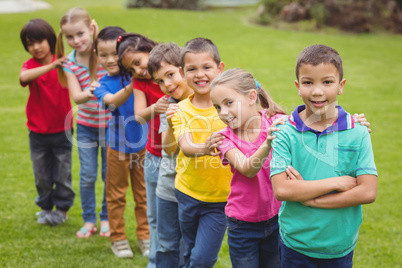 Cute pupils smiling at camera outside