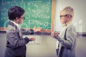 Pupils dressed up as teachers discussing in a classroom