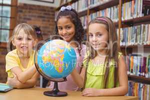 Pupils in library with globe