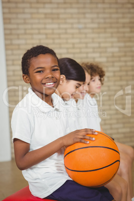 Student holding basketball with fellow players