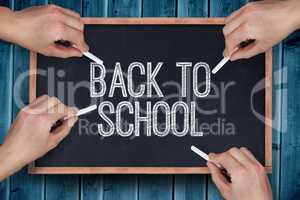 Composite image of multiple hands writing with chalk