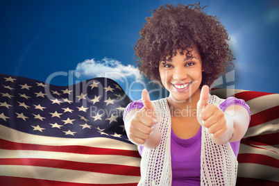 Composite image of smiling woman showing thumbs up