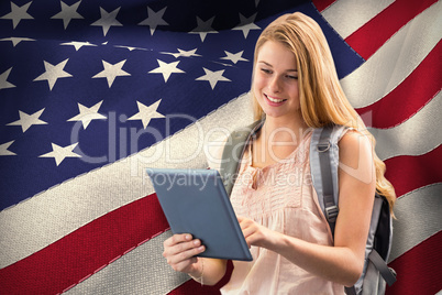 Composite image of happy student using tablet