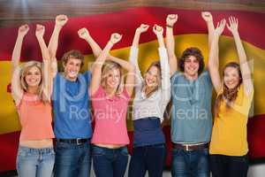 Composite image of a group of people with their hands raised