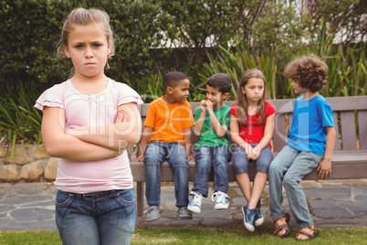 Upset child standing away from group