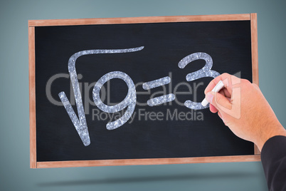 Composite image of hand writing with chalk