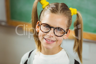 Cute pupil smiling to camera in a classroom