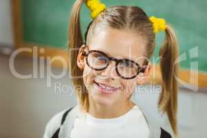 Cute pupil smiling to camera in a classroom