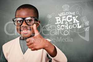 Composite image of cute pupil showing thumbs up