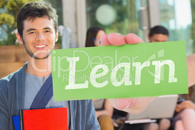 Learn against happy student smiling at camera outside on campus