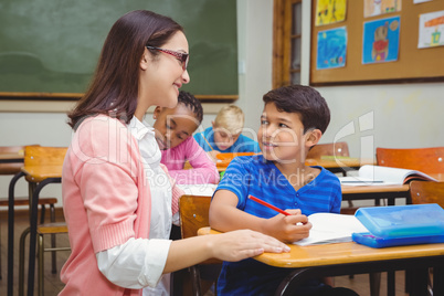 Happy teacher helping her students