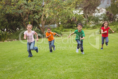 Happy kids running across the grass