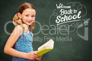 Composite image of girl reading book in library