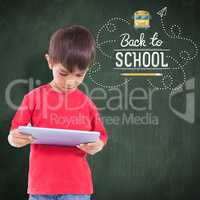 Composite image of cute boy using tablet